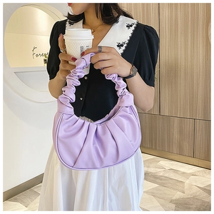 Detail of lavender purple pleated dumpling bag with soft ruffled handle texture