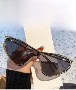 Détail de lunettes de soleil œil de chat dorées avec des verres gris intégraux