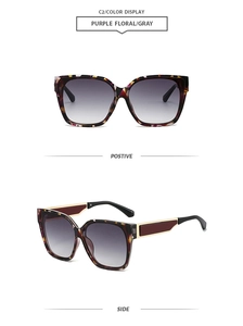Detail view of purple floral square frame sunglasses with gold accents and gradient lenses