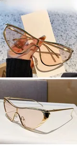 Détail de lunettes œil de chat dorées avec verres marron clair et monture métallique fine