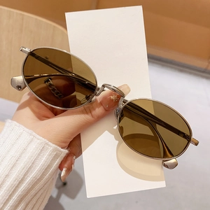 Chic oval vintage sunglasses with brown lenses and a slim silver metal frame for women