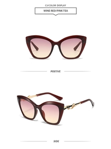 Détail de lunettes de soleil œil de chat bordeaux avec verres dégradés et décor doré