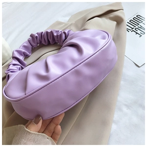 Detail shot of lavender cloud handbag showing soft pleated texture and PU leather finish