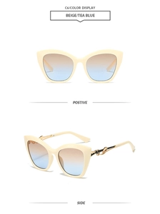 Détail de lunettes de soleil œil-de-chat beige avec branches dorées et verres dégradés