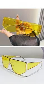 Macro detail of oversized metal frame sunglasses with night vision yellow tinted lenses