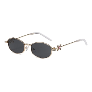 Chic polygonal gold metal sunglasses with grey lenses and pink rhinestone floral details