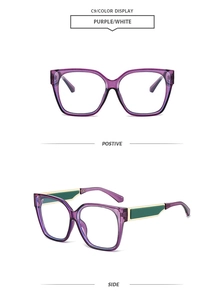 Detail view of purple transparent square frames with green and gold accented temples