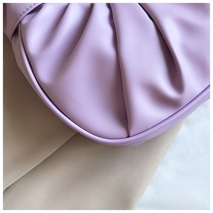 Detailed macro view of soft purple pleated texture on the stylish cloud dumpling bag