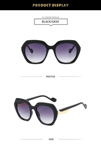 Detail of polygonal black sunglasses with purple gradient lenses and gold accents