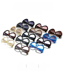 Top view of various colorful oversized cat-eye sunglasses with thick frames for fashion