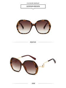 Detail view of leopard frame sunglasses with gradient lenses and pearl hinge accent
