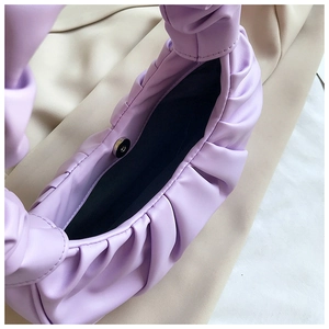 Detail of lavender dumpling bag showing magnetic closure and soft pleated texture