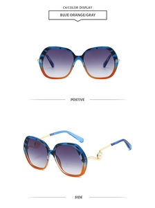 Detail of gradient blue orange sunglasses frame with golden temple and pearl accent