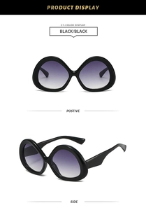 Detail view of triangular penguin egg sunglasses with black thick frames and purple lenses