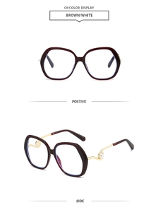 Detail of round oversized sunglasses with brown frames and pearl-embellished temples