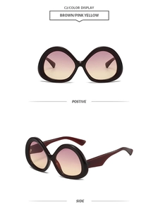 Close-up of retro brown oversized sunglasses with pink-yellow gradient lenses and side view