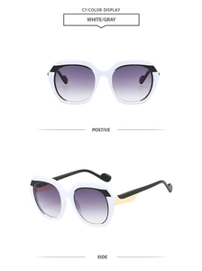 Detail of white polygon sunglasses with gray gradient lenses and gold temple accents
