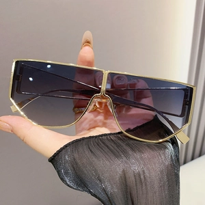 Oversized shield sunglasses with gold metal frame and blue-purple gradient lenses