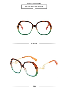 Detail of round oversized sunglasses with orange green frame and pearl temple accents