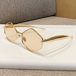 Fashion geometric hexagonal sunglasses with gold metal frame and orange tinted lenses