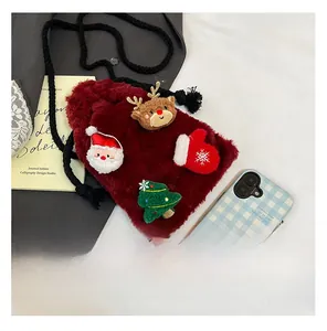 Detail view of red plush Christmas crossbody bag with Santa Claus and reindeer patches