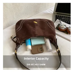 Detail shot of brown suede hobo bag interior showing capacity for daily essentials