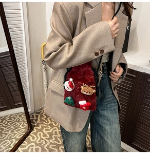 Plush red Christmas crossbody bag featuring festive 3D cartoon appliques and drawstring closure