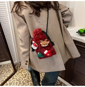 Detail of red plush Christmas crossbody bag featuring Santa and reindeer ornaments