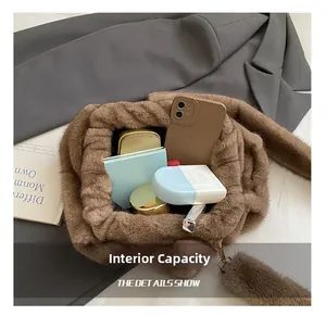 Internal capacity of brown plush crossbody bag showing phone and cosmetics storage