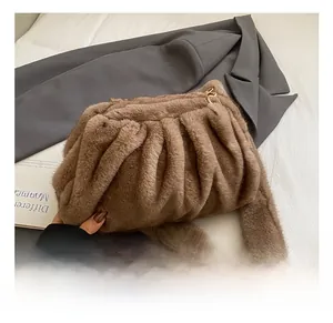 Close-up of brown faux fur crossbody bag with soft cloud pleats and gold chain link