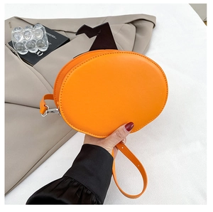 Detail of orange pumpkin bag with black bat decor and silver-tone hardware accents