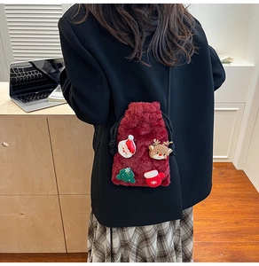 Detail of burgundy plush Christmas crossbody bag featuring festive applique embroidery