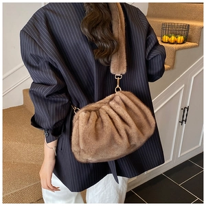 Close-up of a brown faux fur cloud bag with soft plush texture and pleated design