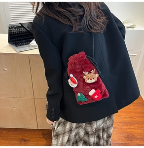 Macro shot of burgundy plush festive crossbody bag featuring Christmas themed embroidery