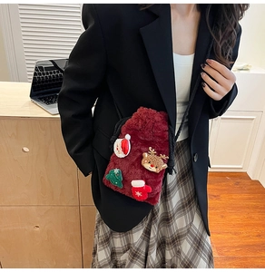 Detail of burgundy plush Christmas crossbody bag featuring festive applique decorations