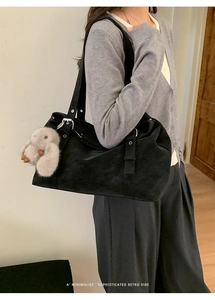 Close-up of black retro tote bag with large capacity and cute plush bunny charm