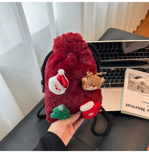 Detail of burgundy plush Christmas drawstring bag with 3D Santa and reindeer patches