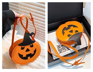 Detail of pumpkin-shaped crossbody bag with a black wizard hat accent and smiling face