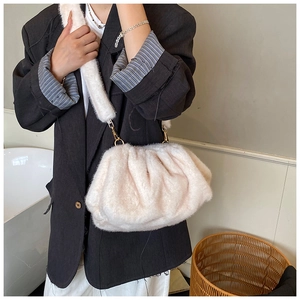 Detail of soft cream plush cloud bag with fluffy shoulder strap and metal hook