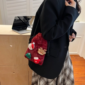 Chic red plush drawstring bag with festive 3D Christmas embroidery worn by a model
