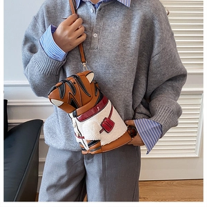 Detailed view of the tiger shaped leather bucket bag with white fleece jacket design