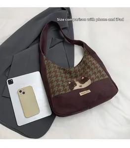 Detail view of large houndstooth tote bag compared with iPad for scale reference