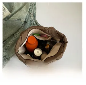 Top view showing spacious interior of brown quilted tote bag with a zipper pocket