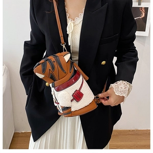 Detail view of tiger-shaped bucket bag with brown pebbled leather and soft shearling
