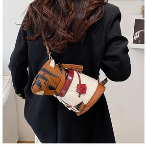 Detail of dog-shaped crossbody bag featuring brown leather and white fleece textures