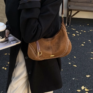 Minimalist brown suede shoulder bag with contrast stitching and golden hardware detail