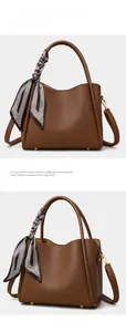 Detailed view of brown lychee texture leather bucket bag with silk scarf on handle