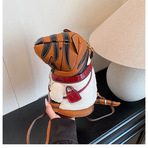 Detail of tiger-shaped crossbody bag with brown leather, white plush, and red mini pouch