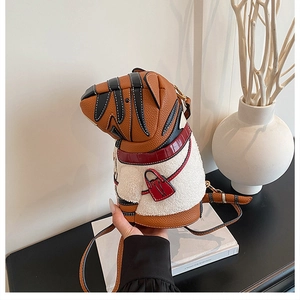 Detail of cartoon tiger bucket bag featuring white faux fur and brown leather texture
