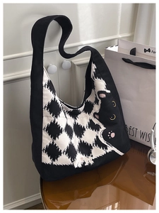 Detail of the black and white checkered canvas tote bag with a cute cat print and ears